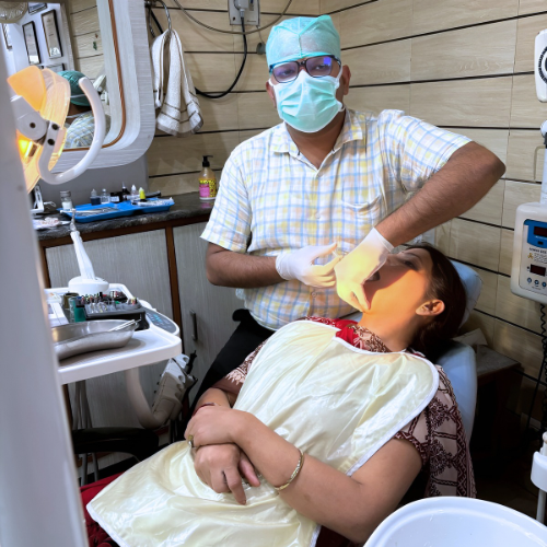 Best Dentist in Meerut, Dr. Abhinav Kansal, performing expert dental treatment on a patient at Kansal Dental Care